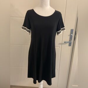 Laura Petite Baseball Dress  black dress with rounded hemline .